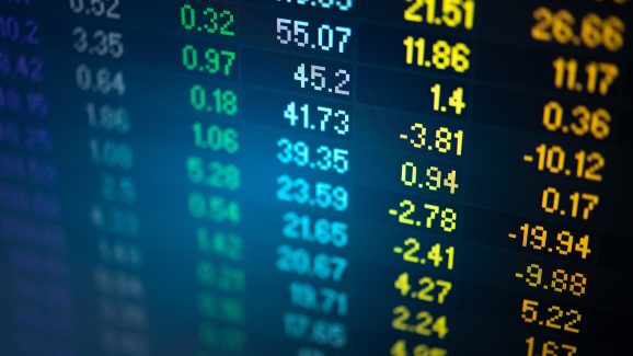 A picture of an abstract financial trading graphs and digital number on monitor meant to represent stock market trend. Colour of the text are gold and blue digital.