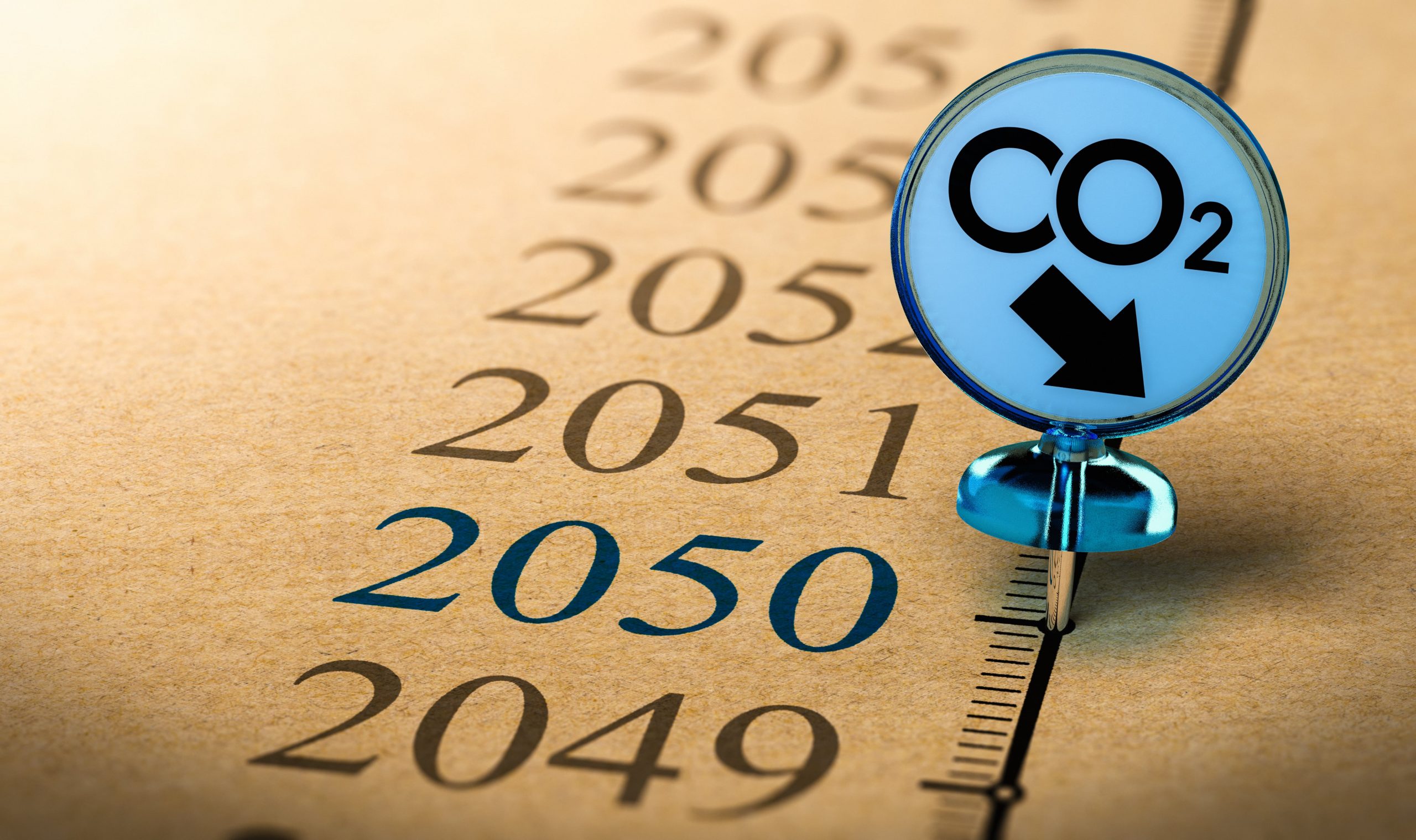 Concept of climate plan and carbon dioxide reduction - Pushpin with the text CO2 pined on a timeline in front of the year 2050.